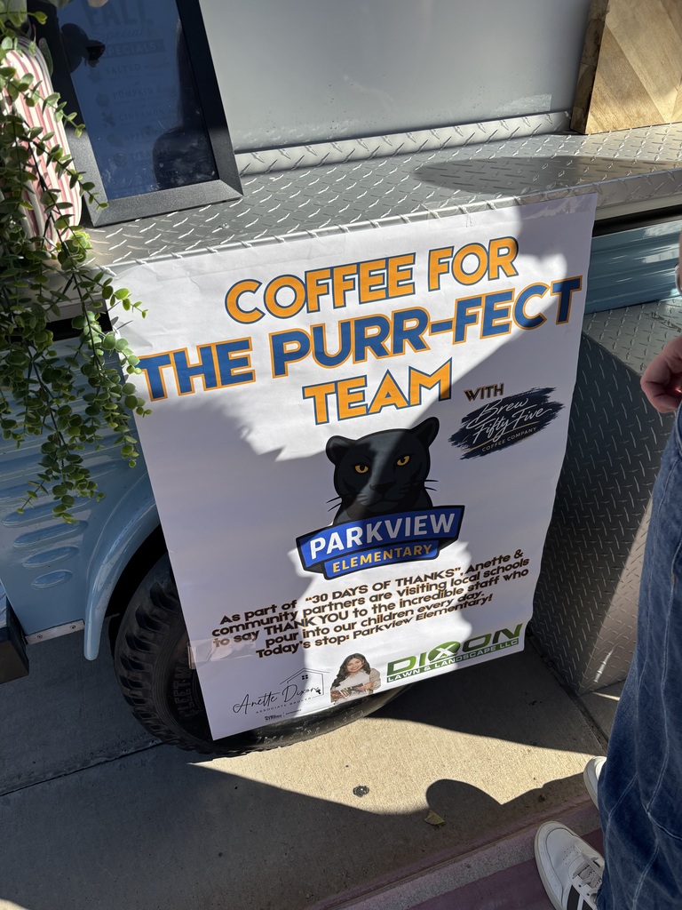 A coffee cart displays a sign that reads "Coffee for the Purr-fect Team" with a black cat image.