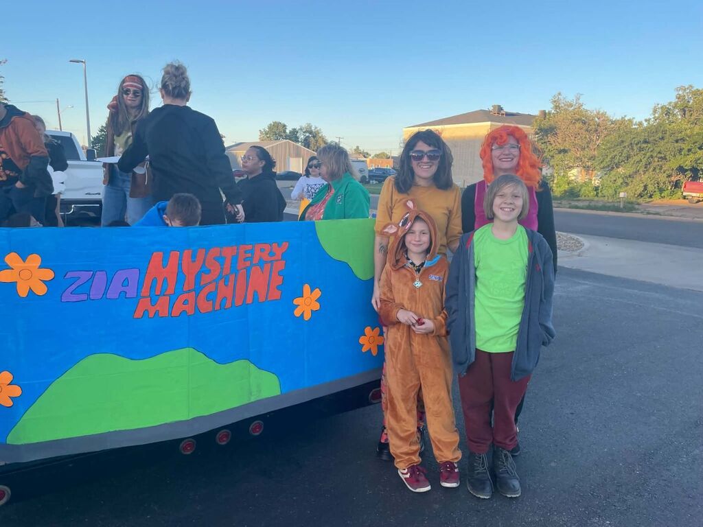 Students, parents, and staff in a parade for homecoming.