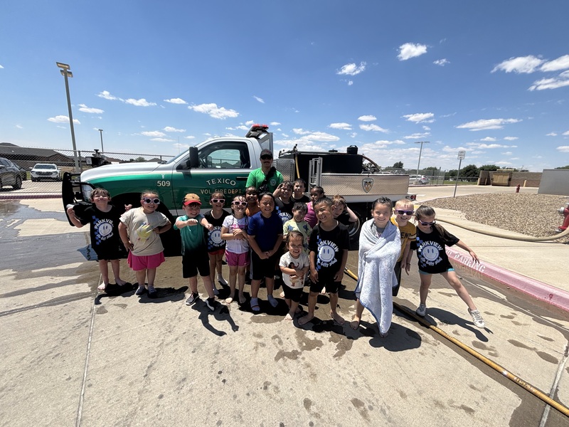 students in front of a fire truck