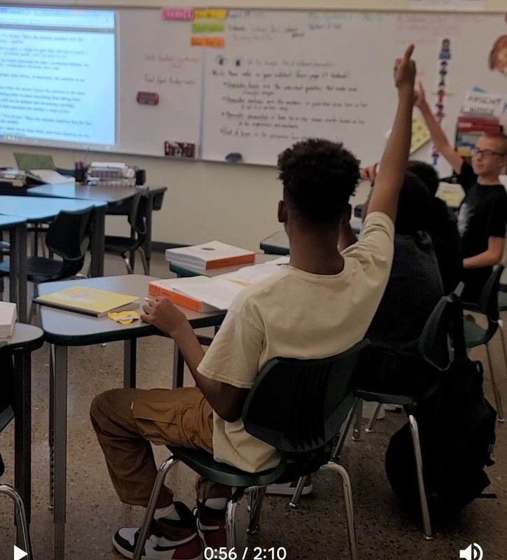 Students giving a thumbs up in agreement of an answer