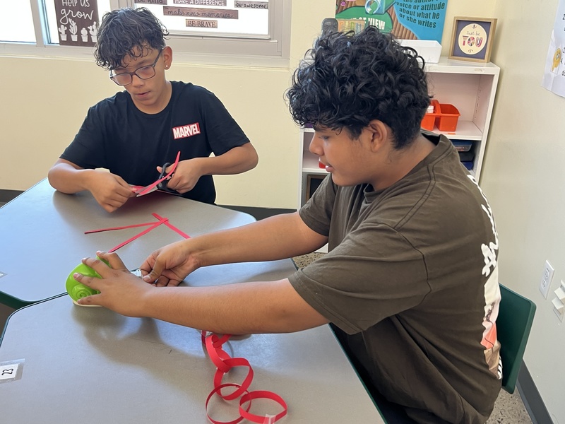 Students working on their paper chain/time management activity in CUB class.