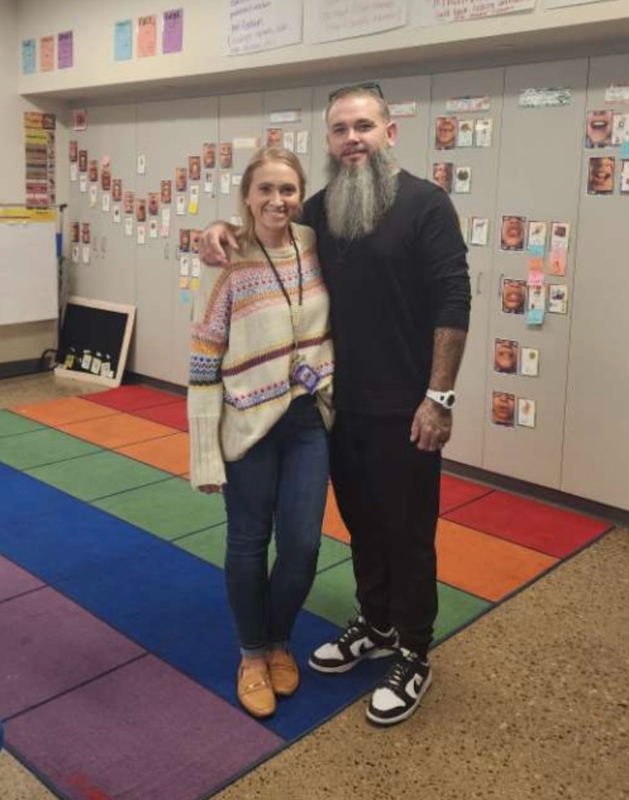A teacher and her brother smiling