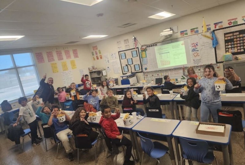 2nd grade students holding up the number 1.