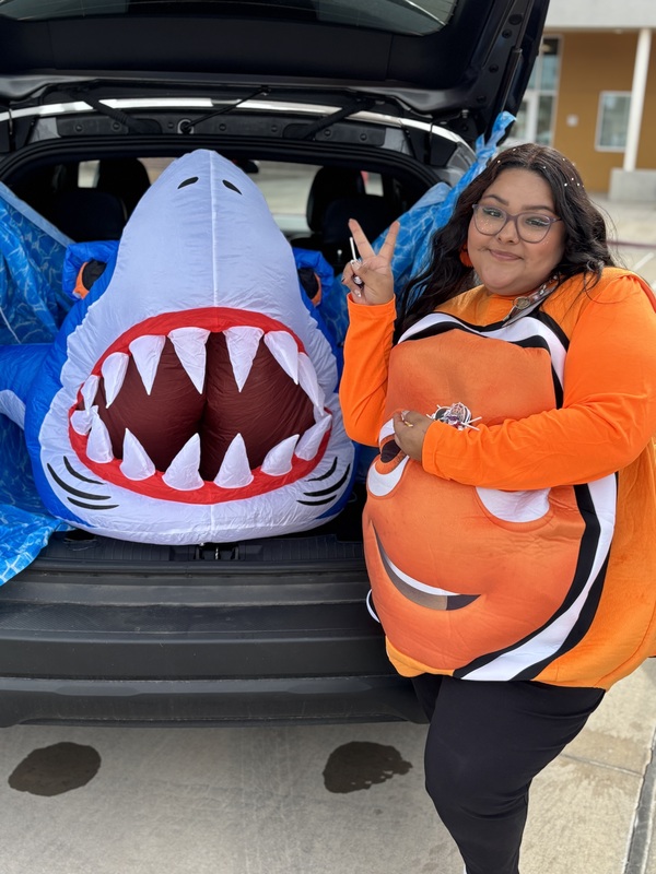 Lady dressed as Nemo in front of Shark