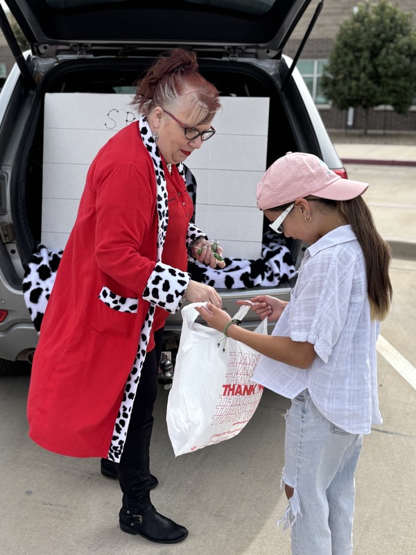 Lady passing out candy to student