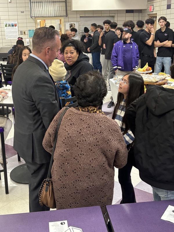 Student shaking hands with  the Mayor