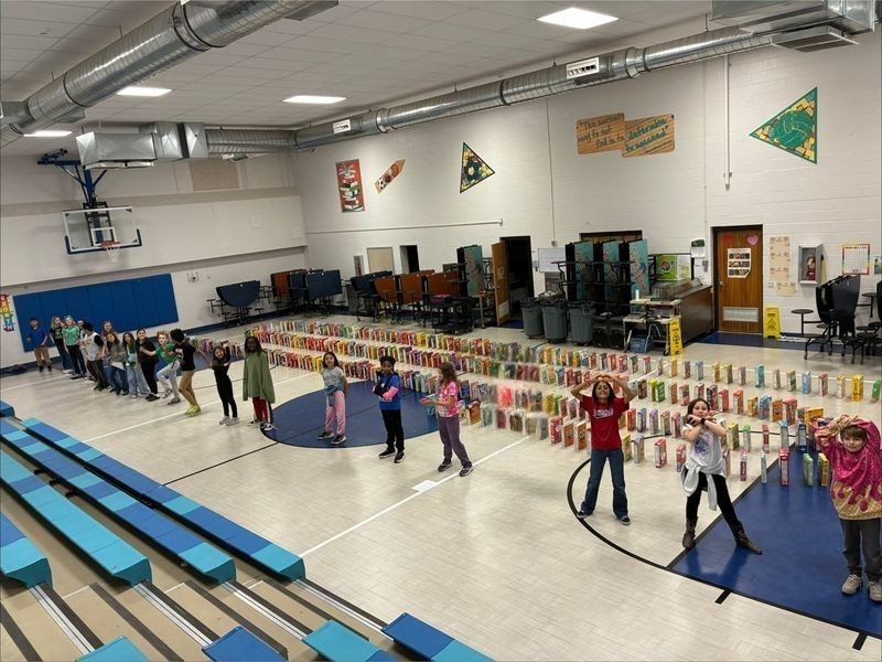 Barry students setting up cereal boxes like dominos