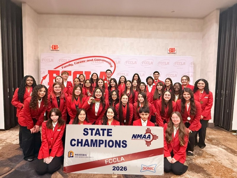 CHS FCCLA Members stand with State Champions sign