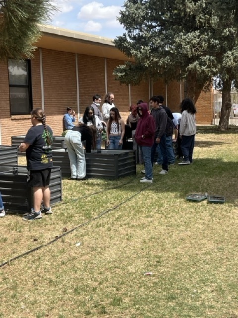Students fill planters with soil