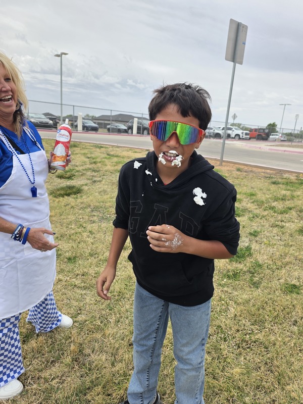 1 student with whipped cream on their face