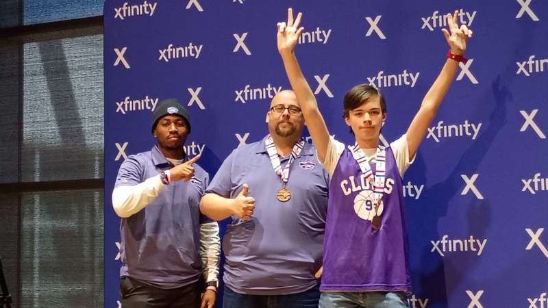 Student and coaches with medals