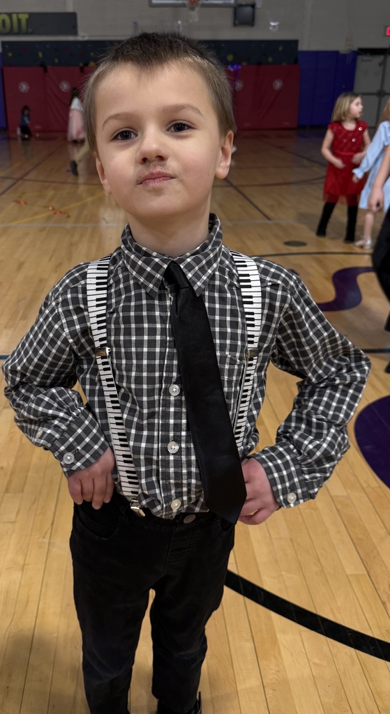 children pose at a school dance