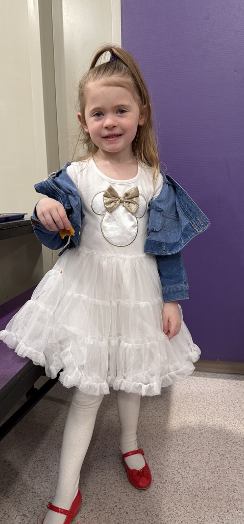 child poses at a school dance