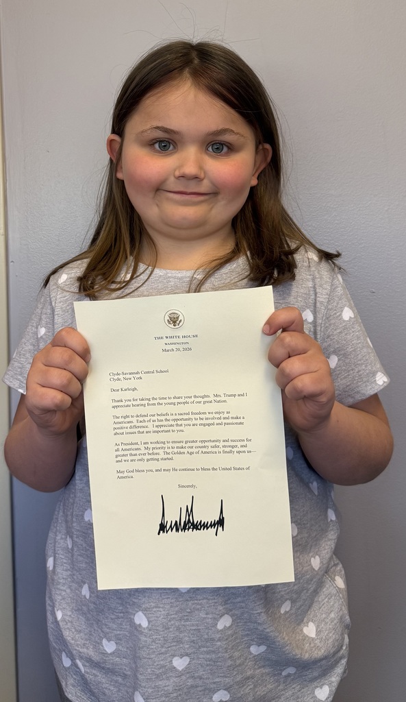 child poses holding a letter