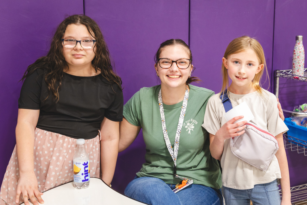 three people at the earth day event