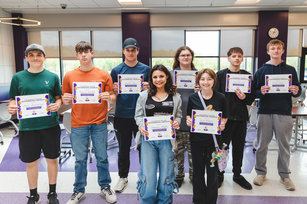 students posing with certificates of achievement
