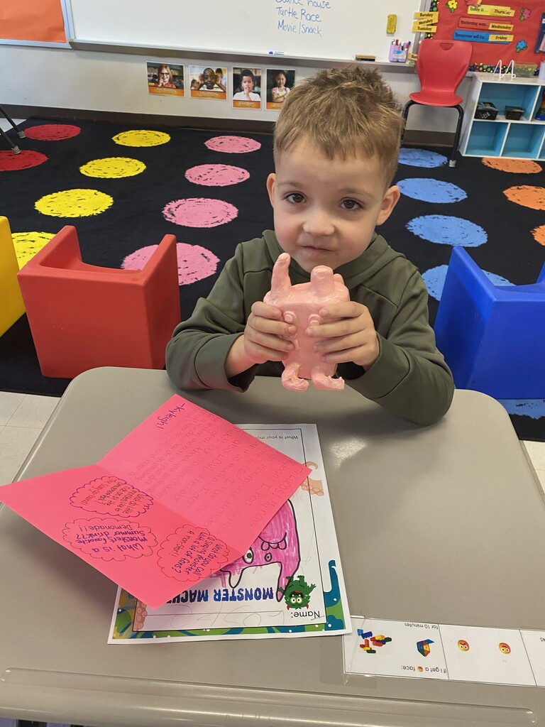kindergartener holding clay monster