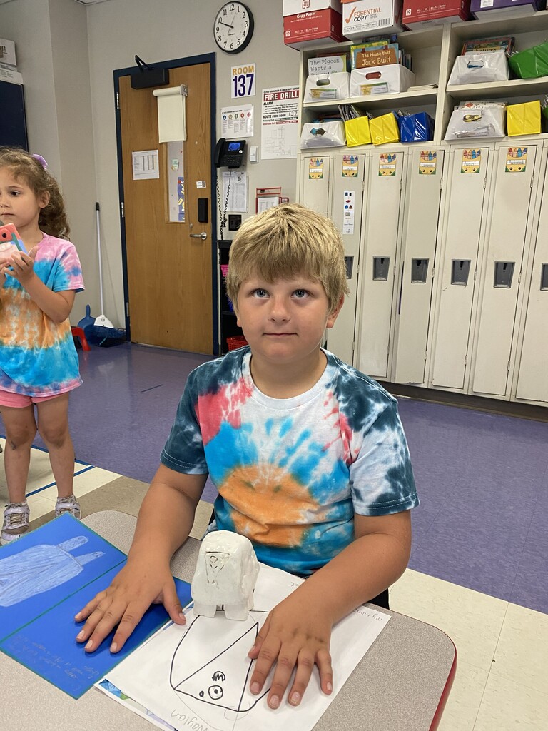 kindergartener holding clay monster