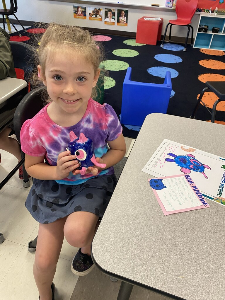 kindergartener holding clay monster
