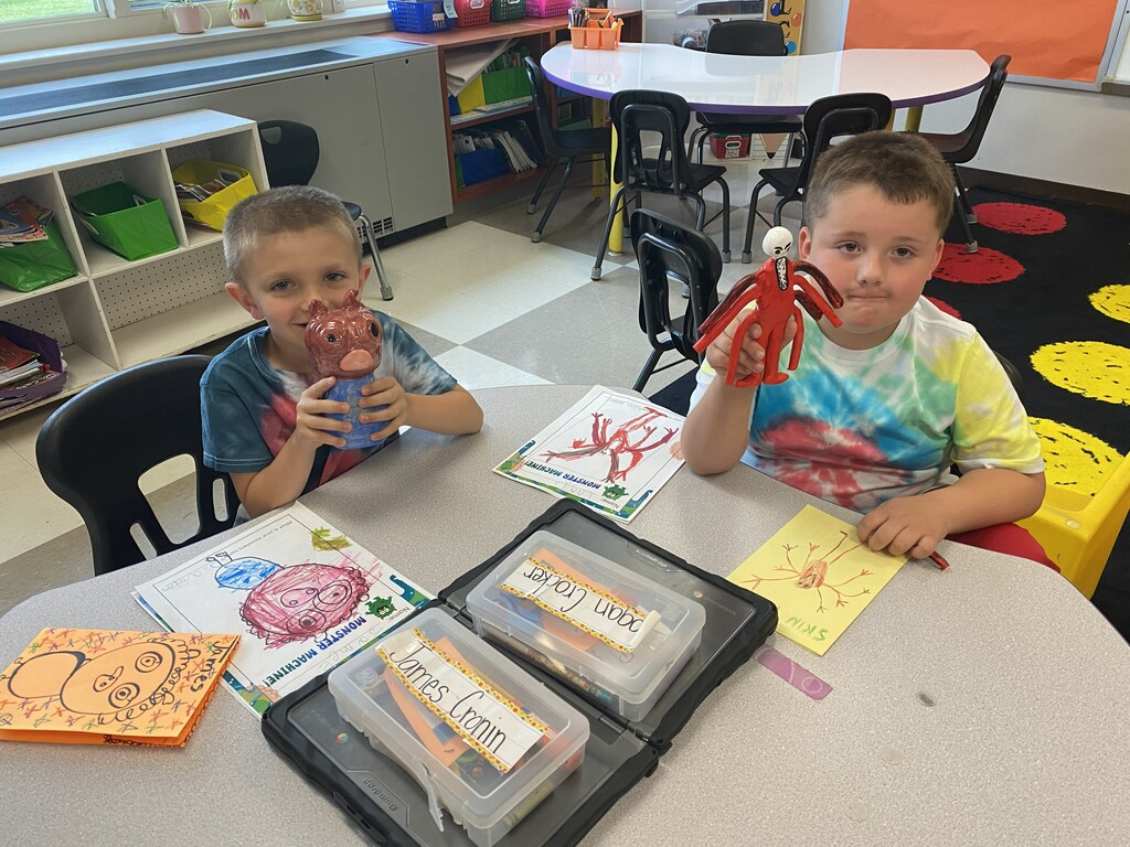 kindergartener holding clay monster