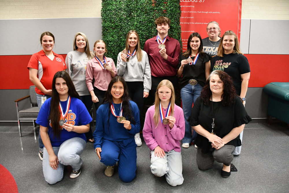 Several students from the Coahoma High School academic team pose for a photo with their coaches