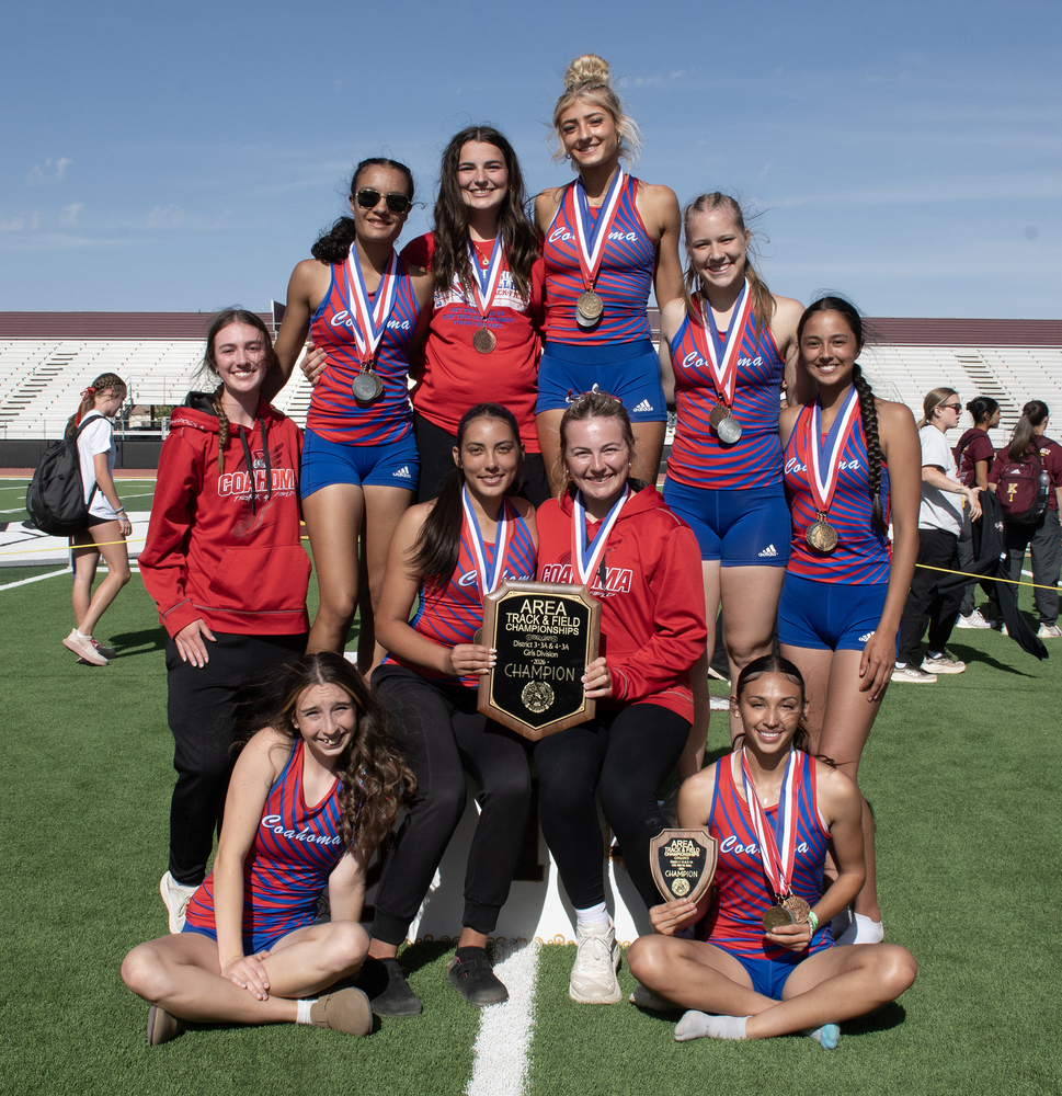 Track girls team posing with their championship meet trophy