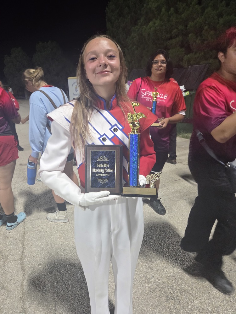 Band drum major holding trophies