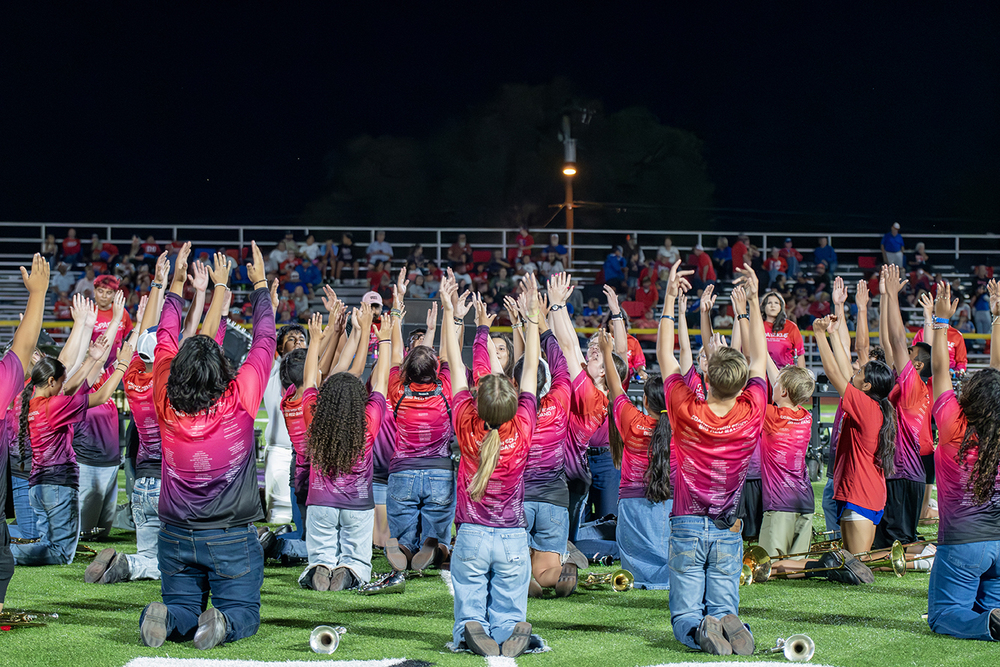 Band members performing at a football game