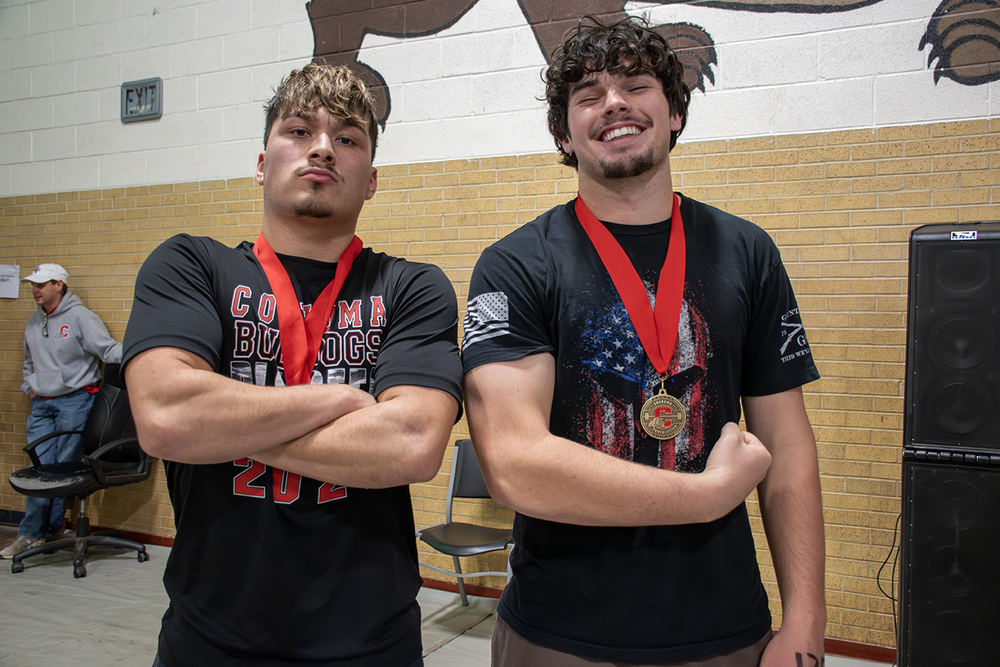 High school boys posing with their powerlifting medals