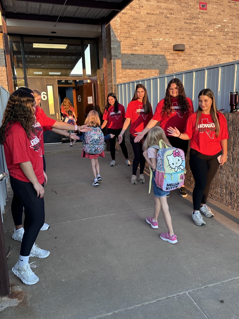students being greated at the door