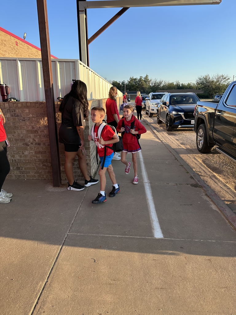 students being welcome by young adults