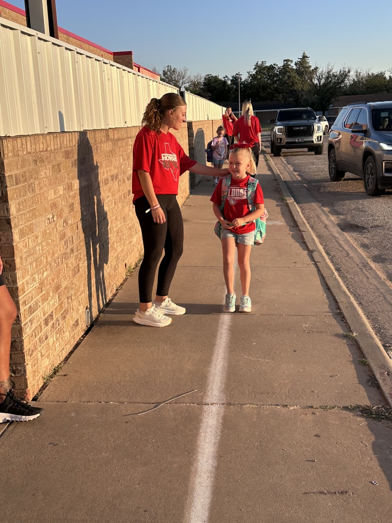 students being greeted by young adults