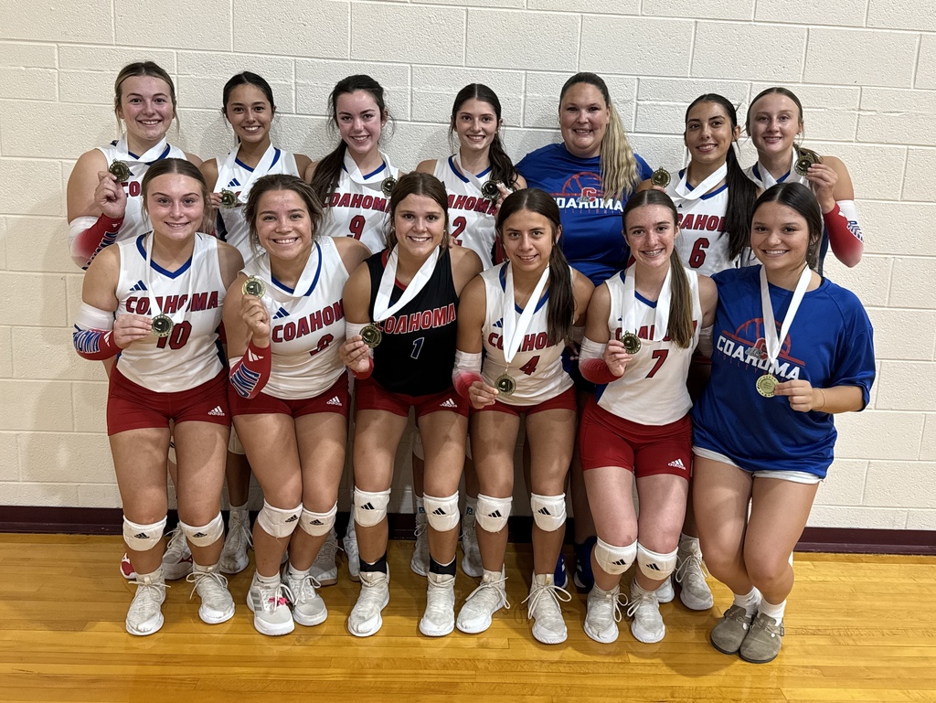 volleyball team holding medals