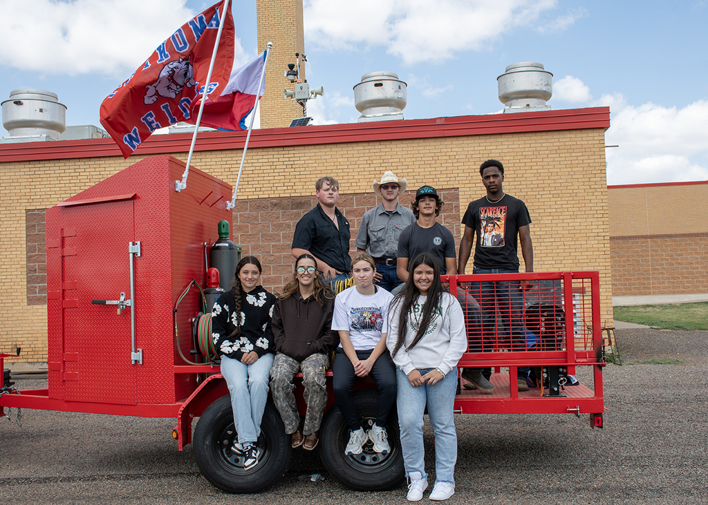 Students sitting on a trailer
