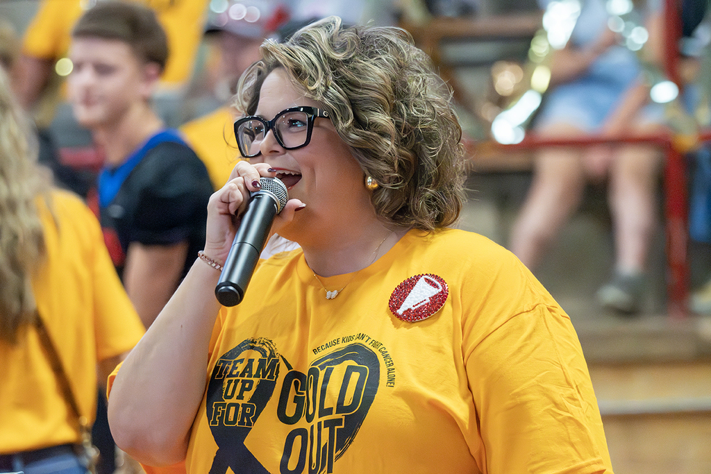 Woman speaking at a pep rally