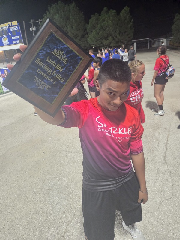 Band student holding a trophy