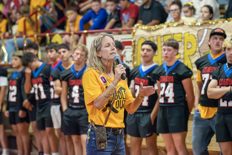 Woman speaking at a pep rally