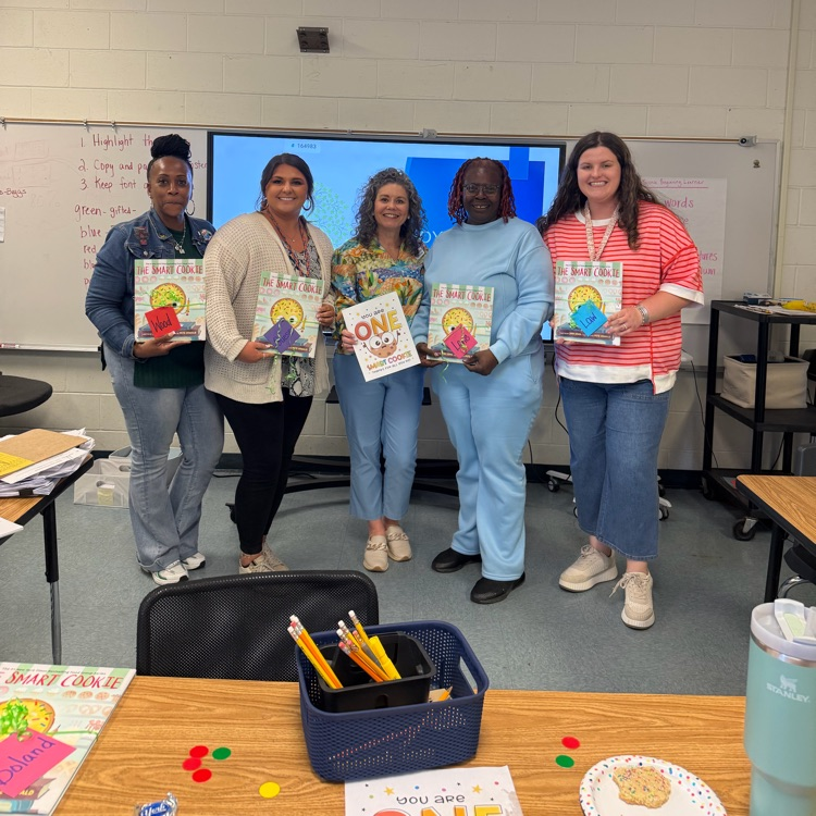 teacher posing with read aloud text