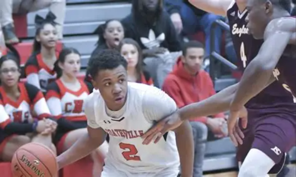 boy dribbling basketball in a game