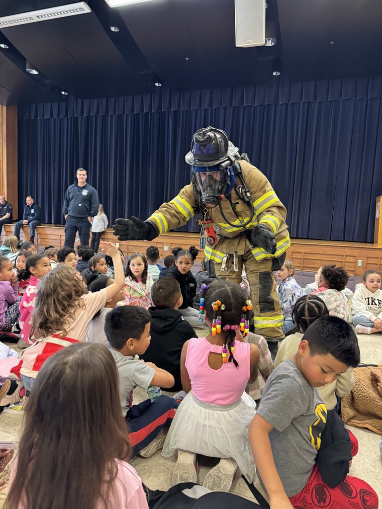 Rainbow students are visited by local firefighters to learn about fire safety.