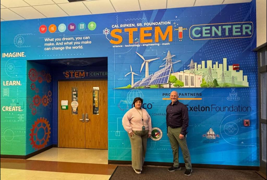 Mrs. Elicker and Mr. K with new STEM Room Wrap
