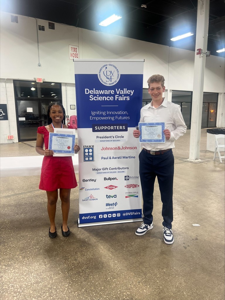 Picture of Harlow and George holding up their certificates in front of a sign that reads "Delaware Valley Science Fair."