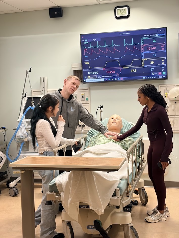 Students learning to assess a patient.