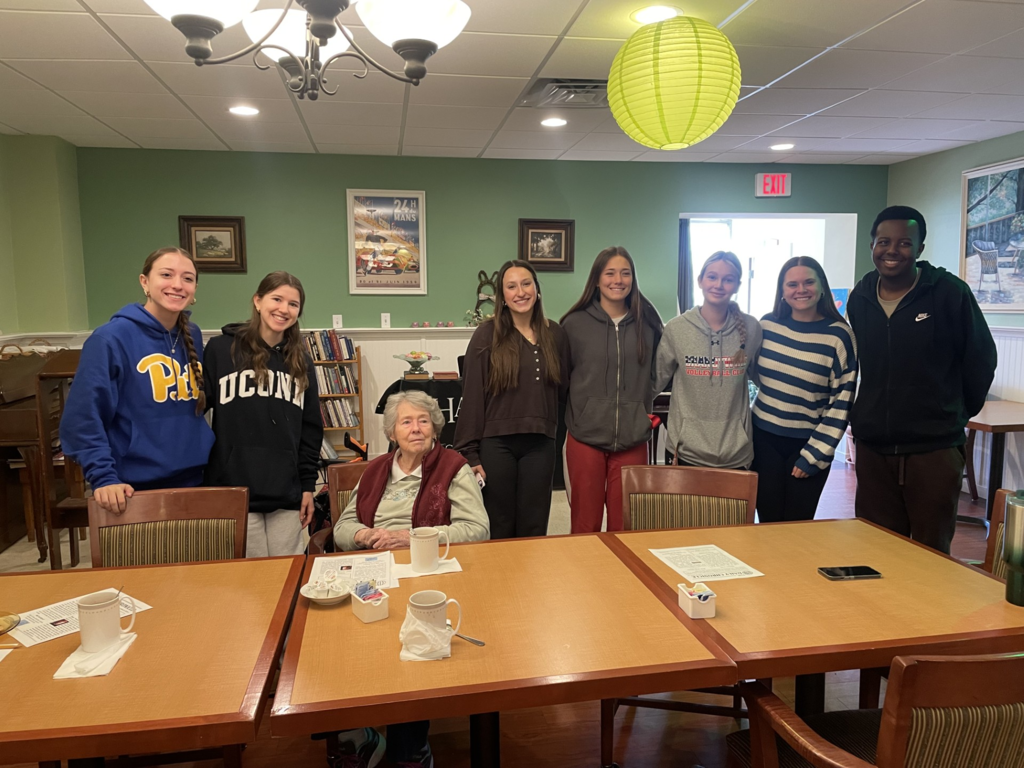 Picture of CASH Interact Club seniors with residents of the Harrison House.