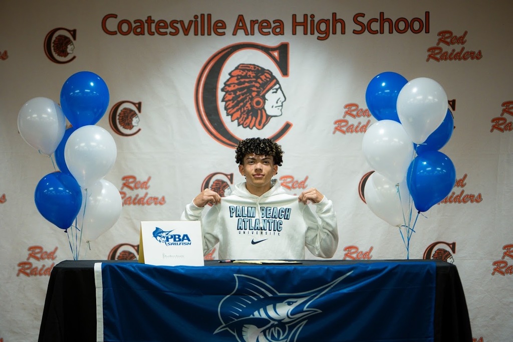 Picture of Andrew Winianas showing off his Palm Beach Atlantic swag.