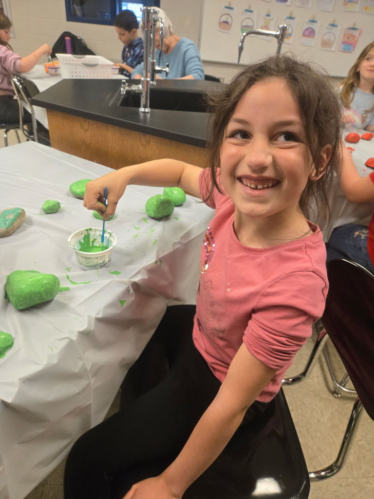 Rainbow Garden Club student painting rocks.