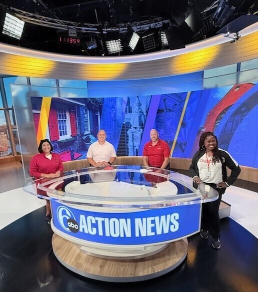 The CASD Athletic Director, Principal of CASH, Principal of CAIHS, and the Director of Climate and Belonging behind the news desk at 6ABC.