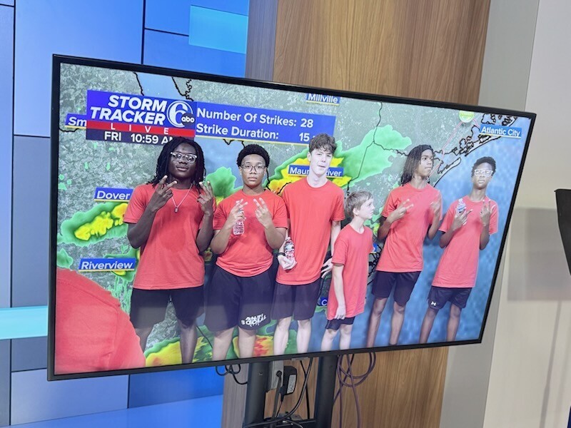 Red Raider Marching Band posing for a picture in front of Storm Tracker at 6ABC.