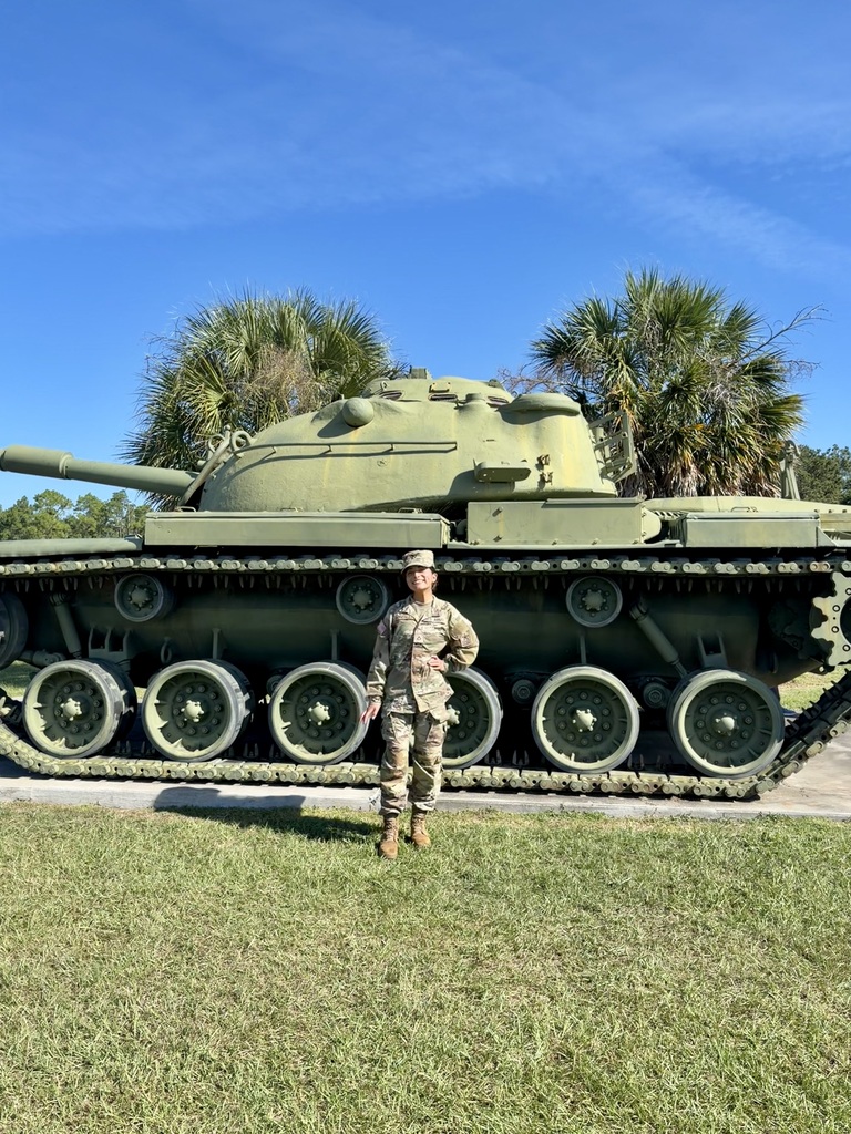 Fatima Gonzalez-Alpizar in fatigues in front of a tank.