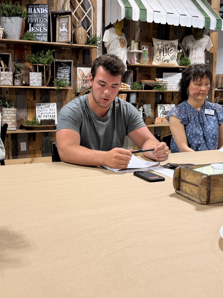 Student sitting at Cole Camp Chamber meeting with other members